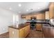 Modern kitchen with an island, stainless steel appliances and tile flooring at 1210 W Agrarian Hills Dr, San Tan Valley, AZ 85143