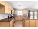 Bright kitchen with an island, stainless steel appliances and wooden cabinetry at 1210 W Agrarian Hills Dr, San Tan Valley, AZ 85143