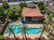 Stunning aerial view of the community pool and clubhouse surrounded by lush greenery at 1850 E Maryland Ave # 63, Phoenix, AZ 85016