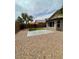 Expansive backyard with an artificial lawn, stone patio, and desert landscaping at 3229 W Five Mile Peak Dr, San Tan Valley, AZ 85144
