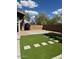 The backyard features some synthetic lawn and a stone area, as well as a privacy fence and some nice landscaping at 3229 W Five Mile Peak Dr, San Tan Valley, AZ 85144