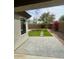 Charming backyard featuring lush green turf and an inviting stone patio area at 3229 W Five Mile Peak Dr, San Tan Valley, AZ 85144