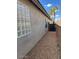 The exterior of the property features a glass block window for privacy and some desert landscaping. The property has a fence at 3229 W Five Mile Peak Dr, San Tan Valley, AZ 85144