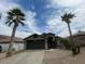 Inviting single-story home with a landscaped yard featuring mature palm trees and a well-kept gravel area at 3229 W Five Mile Peak Dr, San Tan Valley, AZ 85144