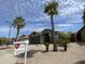 Charming single-story home with desert landscaping, palm trees, and a real estate sign on the lawn at 3229 W Five Mile Peak Dr, San Tan Valley, AZ 85144
