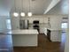 Open kitchen featuring white cabinets, quartz countertops, a center island, and stainless steel appliances at 3229 W Five Mile Peak Dr, San Tan Valley, AZ 85144