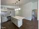 Modern kitchen with quartz countertops, a center island with pendant lighting, and stainless steel appliances at 3229 W Five Mile Peak Dr, San Tan Valley, AZ 85144