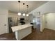 Open kitchen featuring white cabinets, quartz countertops, a center island, and stainless steel appliances at 3229 W Five Mile Peak Dr, San Tan Valley, AZ 85144