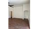 Spacious living area with modern wood-look floors, high ceilings, and an arched decorative alcove at 3229 W Five Mile Peak Dr, San Tan Valley, AZ 85144