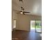 Open-concept living space with wood-look floors, a ceiling fan, and sliding glass doors to the outdoor patio at 3229 W Five Mile Peak Dr, San Tan Valley, AZ 85144