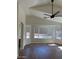 Bright living room with a vaulted ceiling, modern ceiling fan, and large windows providing ample natural light at 3229 W Five Mile Peak Dr, San Tan Valley, AZ 85144