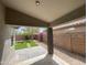 Covered patio overlooks a manicured backyard with artificial turf and desert landscaping at 3229 W Five Mile Peak Dr, San Tan Valley, AZ 85144
