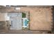 Backyard showcases a sparkling pool, patio area, and spacious desert lot ready for landscaping, plus a home's roof at 34047 N 10Th St, Phoenix, AZ 85085