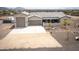 Aerial view of home showcasing driveway, xeriscaping and large three-car garage at 34047 N 10Th St, Phoenix, AZ 85085