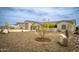 Exterior elevation of a home with xeriscaping, three-car garage, and a boat at 34047 N 10Th St, Phoenix, AZ 85085