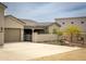 Home exterior featuring a three-car garage, desert landscaping, and private front courtyard at 34047 N 10Th St, Phoenix, AZ 85085