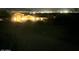 Night view of a residence featuring outdoor lighting and a view of the cityscape in the distance at 34047 N 10Th St, Phoenix, AZ 85085