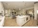 View of the open concept kitchen, living and dining area with an island, fireplace, and light color scheme at 34047 N 10Th St, Phoenix, AZ 85085