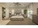 Spacious bedroom features an ensuite bathroom, sliding glass doors to patio, and a ceiling fan at 34047 N 10Th St, Phoenix, AZ 85085