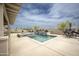 Backyard pool and spa with outdoor seating and desert landscaping under a sunny, partly cloudy sky at 34047 N 10Th St, Phoenix, AZ 85085