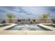A backyard pool with a water feature and spa is surrounded by desert landscaping under a cloudy sky at 34047 N 10Th St, Phoenix, AZ 85085