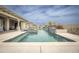Backyard pool features clean lines, a modern water feature and desert landscaping under a partly cloudy sky at 34047 N 10Th St, Phoenix, AZ 85085