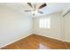 Bedroom with wood floors, closet, window, and neutral colored paint at 3774 W Wood Dr, Phoenix, AZ 85029
