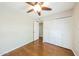 Bedroom with wood floors, closet, ceiling fan and neutral colored paint at 3774 W Wood Dr, Phoenix, AZ 85029