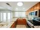 Stylish kitchen with wooden cabinetry, stainless steel appliances, granite countertops, and a skylight at 3774 W Wood Dr, Phoenix, AZ 85029