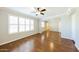 Bright living room with wood floors, a ceiling fan, white shutters, and neutral paint at 3774 W Wood Dr, Phoenix, AZ 85029
