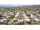 Expansive aerial view of a suburban community with beige houses, mature landscaping, and mountain views at 4106 E Lavender Ln, Phoenix, AZ 85044