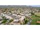 Expansive aerial view of a suburban community with beige houses, mature landscaping, and athletic field at 4106 E Lavender Ln, Phoenix, AZ 85044