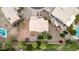 Aerial view of a home with a tile roof, surrounded by mature trees, a backyard, and a pool at 4106 E Lavender Ln, Phoenix, AZ 85044