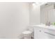 Clean half-bathroom features a modern toilet and vanity with bright lighting at 4106 E Lavender Ln, Phoenix, AZ 85044