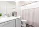 Bright bathroom featuring a gray vanity, brushed nickel faucet, and shower with light gray shower curtain at 4106 E Lavender Ln, Phoenix, AZ 85044