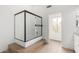 Bathroom featuring tiled shower with glass enclosure, modern fixtures, and bright natural light at 4106 E Lavender Ln, Phoenix, AZ 85044