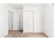 Bedroom with standard closet, carpeted floor, and white walls, offering simple design at 4106 E Lavender Ln, Phoenix, AZ 85044