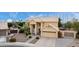Aerial view of a tan two-story house with a tile roof, large windows, and a well-maintained front yard at 4106 E Lavender Ln, Phoenix, AZ 85044