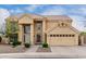 Tan two-story home with well-manicured landscaping, and a spacious two-car garage at 4106 E Lavender Ln, Phoenix, AZ 85044