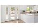 Bright kitchen with white cabinets, stylish hardware, and views of outdoor patio at 4106 E Lavender Ln, Phoenix, AZ 85044