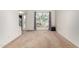 Bright living room with large window, neutral carpet, and staircase access at 4106 E Lavender Ln, Phoenix, AZ 85044