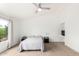Bright main bedroom with a ceiling fan and plenty of natural light from the large window at 4106 E Lavender Ln, Phoenix, AZ 85044