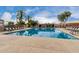 Large community swimming pool with lounge chairs and palm trees, creating a resort-like atmosphere at 4106 E Lavender Ln, Phoenix, AZ 85044