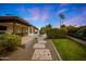 Landscaped backyard featuring decorative tile, seating and a covered patio with views of the home and the lawn at 5001 E Redfield Rd, Scottsdale, AZ 85254
