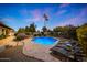 Backyard features a sparkling pool, a lounging area with lounge chairs, and a fire pit with outdoor seating at 5001 E Redfield Rd, Scottsdale, AZ 85254