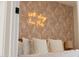 Detail of a bedroom accent wall with lighting that reads 