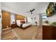 Bright bedroom with hardwood floors, stylish accent wall, comfortable king-size bed, and a mounted television at 5001 E Redfield Rd, Scottsdale, AZ 85254