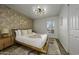 Charming bedroom with unique lighting, an accent wall, and a cozy bed with decorative pillows at 5001 E Redfield Rd, Scottsdale, AZ 85254