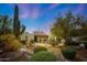 Southwestern-style home featuring a front yard with mature landscaping and a charming water fountain at 5001 E Redfield Rd, Scottsdale, AZ 85254
