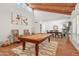 Bright living room with vaulted ceilings, light-colored walls, pool table, and dining area at 5001 E Redfield Rd, Scottsdale, AZ 85254